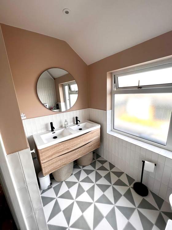Pink-toned bathroom with double vanity