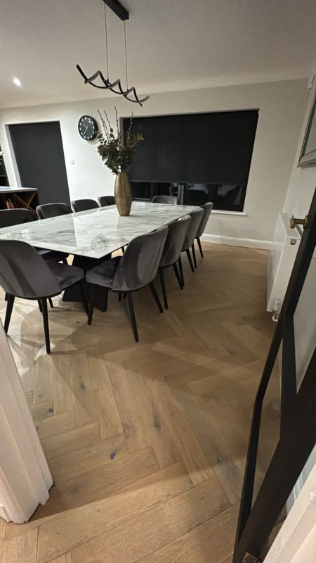 Oak herringbone flooring in an open-plan dining area