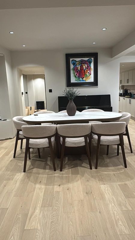 Open-plan dining area with light oak flooring and tiger artwork