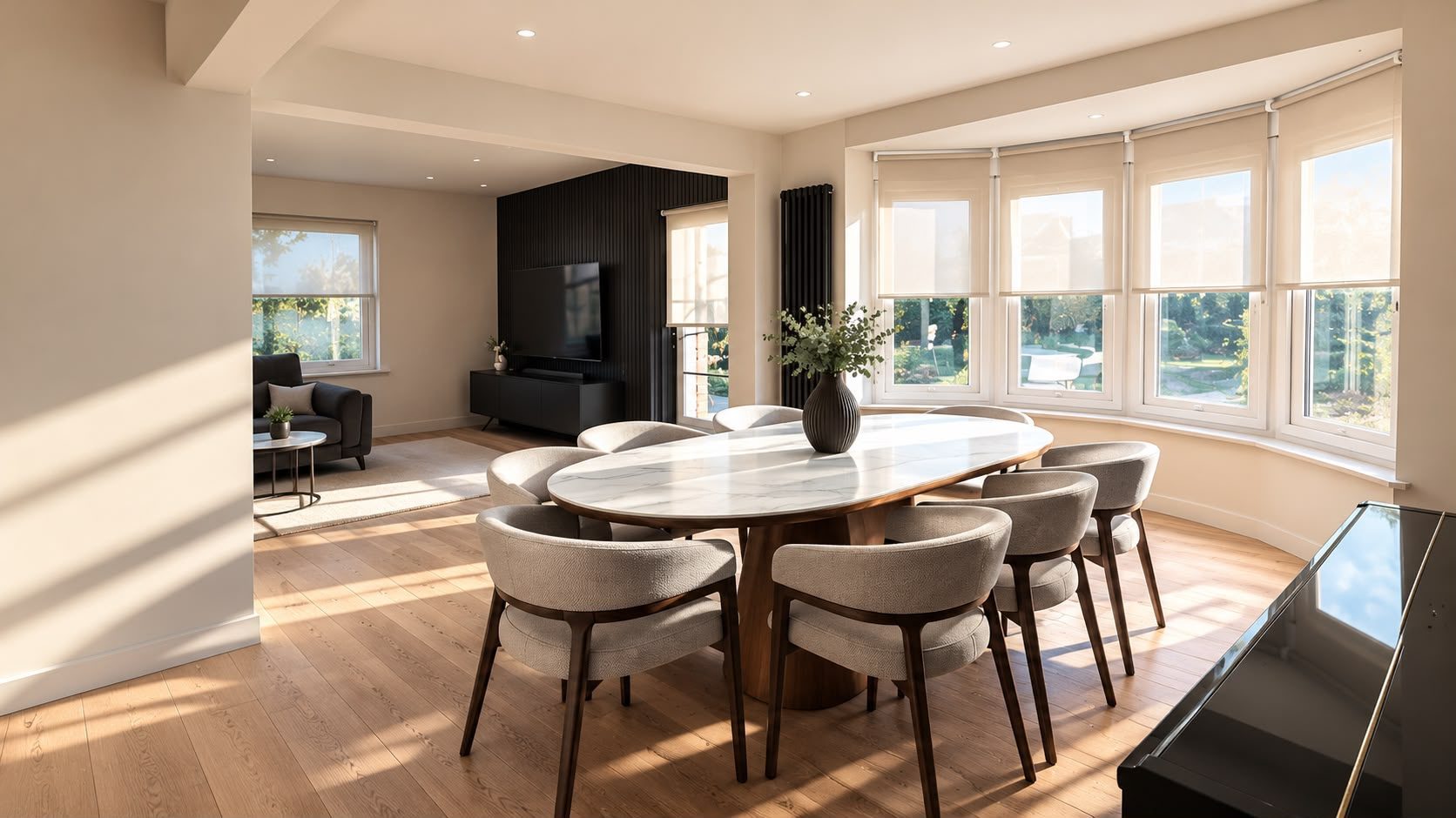 Bright open-plan dining room with bay window and oak floor, by CVS Renovations